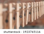 Wooden clothespins on a rope. Selective focus on one clothespin. Copy, empty space for text.
