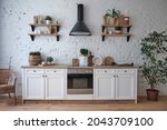 bright kitchen interior with wooden floor, white furniture, utensils, shelves, crockery and houseplants in pot. stylish modern renovation of dining room
