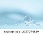 Blue background with transparent glass balls. Minimal concept and soft sunlight.