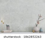 Modern room decoration. Flower pots, candle holder and books on white table with white wall background. 