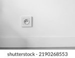 Small photo of socket on white wall with copyspace, electrical planning, convenient, euro sockets. Power sockets, closeup. Electrical supply