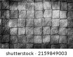 black and white square stone pattern with sun glare