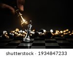 Close up hand choose king chess to challenge battle fighting on chess board concepts of leadership and business strategy and human personal organization risk management.