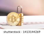Small photo of Bitcoin(BTC) coin with padlock lying on computer background. Bitcoin security. digital cyber safety or security encryption, Blockchain technology to encode online information or data protection.