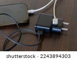 Picture of adapter along with charging cable of 'C' pin kept on a table. Universal cable, pin, charger, Type-C, USB, port, mobile, tablet, laptop, electronic, gadget, EU, India, Global, USA, Apple.