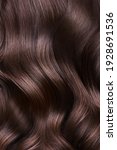 Small photo of A closeup view of a bunch of shiny curls brown hair.