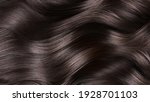 Small photo of A closeup view of a bunch of shiny curls brown hair.