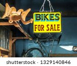 Small photo of ATHENS, GEORGIA, U.S.A. – August 18, 2012: A hand-painted bikes for sale sign hangs next to a carved wooden elephant head in the old Jittery Joe’s Coffee roasting house on Broad Street.