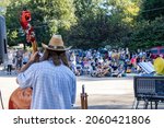 Small photo of Athens, Georgia - October 10, 2021: Bassist Dan Horowitz looks out at the crowd as Klezmer Local 42 plays at the Jittery Joe's Roaster during the annual Boo-Le-Bark fundraising event for AthensPets.
