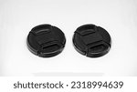 Small photo of Two black camera lens caps with a diameter of 52mm, designed to provide good protection for the camera front glass from dust, scratches and accidental damage.