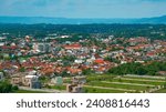 Small photo of Karangpucung Urban Village, Purwokerto, as seen from a lofty vantage point, offers a picturesque blend of natural beauty and urban charm. This view combines the beauty of nature with urban landscape.