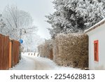Peace snowy path with lamp, house and fence in UNESCO town Telč, Czech republic, Europe