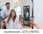 Small photo of Happy and joyful influencer taking a selfie with a professional hairdresser in a salon