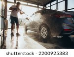Cleaning car using active foam. Man washing his car on self car