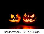Scary Halloween pumpkins isolated on a black background. Scary glowing faces trick or treat