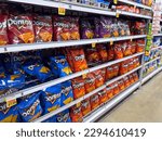 Small photo of Los Angeles, California, United States - 02-01-2023: A view of several shelves dedicated to packages of Doritos chips, on display at a local grocery store.