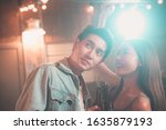 Small photo of Couples dancing,Young Asian people sweetheart philander dancing and drinking in evening party inside a night club hand holding beer bottle with light flare effect
