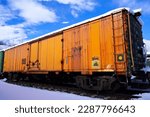 Small photo of Orange Railroad Boxcar Sitting in the Snow