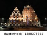 House of the Black Heads lit up at night in the town square of Riga Old Town, Latvia