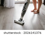 Woman Cleaning A Floor With...