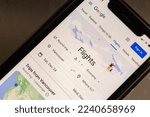 Small photo of Vancouver, CANADA - Dec 9 2022 : Website of Google Flights seen in iPhone. Google Flights is an online flight booking search service for the purchase of airline tickets through third-party suppliers