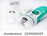 Small photo of Women's electric razor for intimate places. A set of women's razor for hair on a white background. A white electric razor.