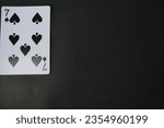 Small photo of ogan ilir,Indonesia-july 22th,2023: seven of Spade . rummy isolate on black background. selective Focus image