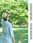 Small photo of Asian young women. like spending time in the middle of nature. wear a hat at a rakish angle. blurred background with copy space.