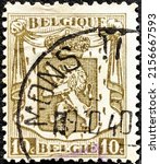 Small photo of Milan, Italy, 16 May 2022: Postage stamp printed in Belgium in 1929 showing Service stamp: Heraldic Lion with overprint winged wheel.