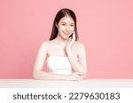 Small photo of Young Asian woman long hair with natural makeup on face have plump lips and clean fresh skin on isolated pink background. Portrait of cute female model in studio. Facial treatment, Cosmetology.