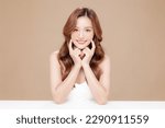 Small photo of Young Asian beauty woman curly long hair with korean makeup style touch her face and perfect skin on isolated beige background. Facial treatment, Cosmetology, plastic surgery.