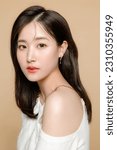 Small photo of Young Asian beauty woman short hair with korean makeup style on face and perfect clear fresh skin on isolated beige background. Facial treatment, Cosmetology, plastic surgery.