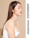 Small photo of Young Asian beauty woman model long hair with korean makeup style on face and perfect skin on isolated beige background. Facial treatment, Cosmetology, Spa, Aesthetic, plastic surgery.