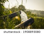 Small photo of pump pipe water flow equipment agriculture,Water from a well filled a pond for irrigation,Irrigation water from the source,Water flow from large pump tube in Farm,being flush out by a heavy tube