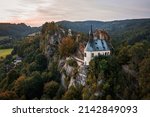 Pantheon in Mala skala, Czech Republic, aerial drone view of a small castle on the mountain in nice autumn sunset