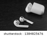 white wireless headphones on a black background. black table