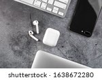 Top view Office desktop with office accessories, Desktop with business objects. metal background. Air Pods. EarPods. with Wireless Charging Case. 