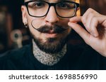 Small photo of Well groomed hipster. Barbershop concept. Beauty industry. Facial hair care. Mature man bearded hipster with long beard and mustache. Styling mustache. Growing long mustache. Moustache style.