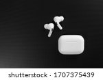 white wireless headphones on black surround background