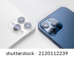 white and blue smartphone lies with cameras up on a white background