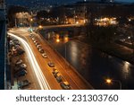 Small photo of TURIN , ITALY - 18 MARCH 2014 : busy road along the river that runs through the city photographed at night with long lead times.