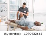 Rehabilitation therapy. Professional male therapist working in the rehabilitation center while doing the therapy