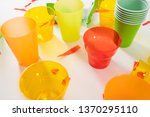 Small photo of Unsystematic consumption. Different colorful plastic cups collected in a pile of harmful garbage