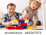 Small photo of Infatuated boy with opened mouth playing with toys