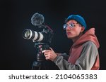 Small photo of Filmmaker or cinematographer using professional camera gear to make documentaries and movies. Young cameraman, audiovisual, story telling and directing movies concepts.