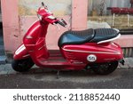 Small photo of Colmar - France - 5 February 2022 - Profile view of red Peugeot django scooterparked in the street