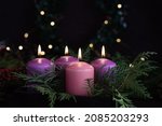 Three purple and one pink advent candles in Christmas eve, catholic symbol.