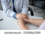 Small photo of Close-up image of a caring and kind doctor holding a patient's hands to comfort and reassure them during a medical checkup at the hospital.