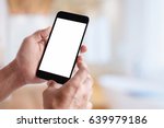 Man holding smart phone with blurred background.  For Graphic display montage.