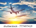 Airplane in the sunset sky flight travel transport airline background concept.